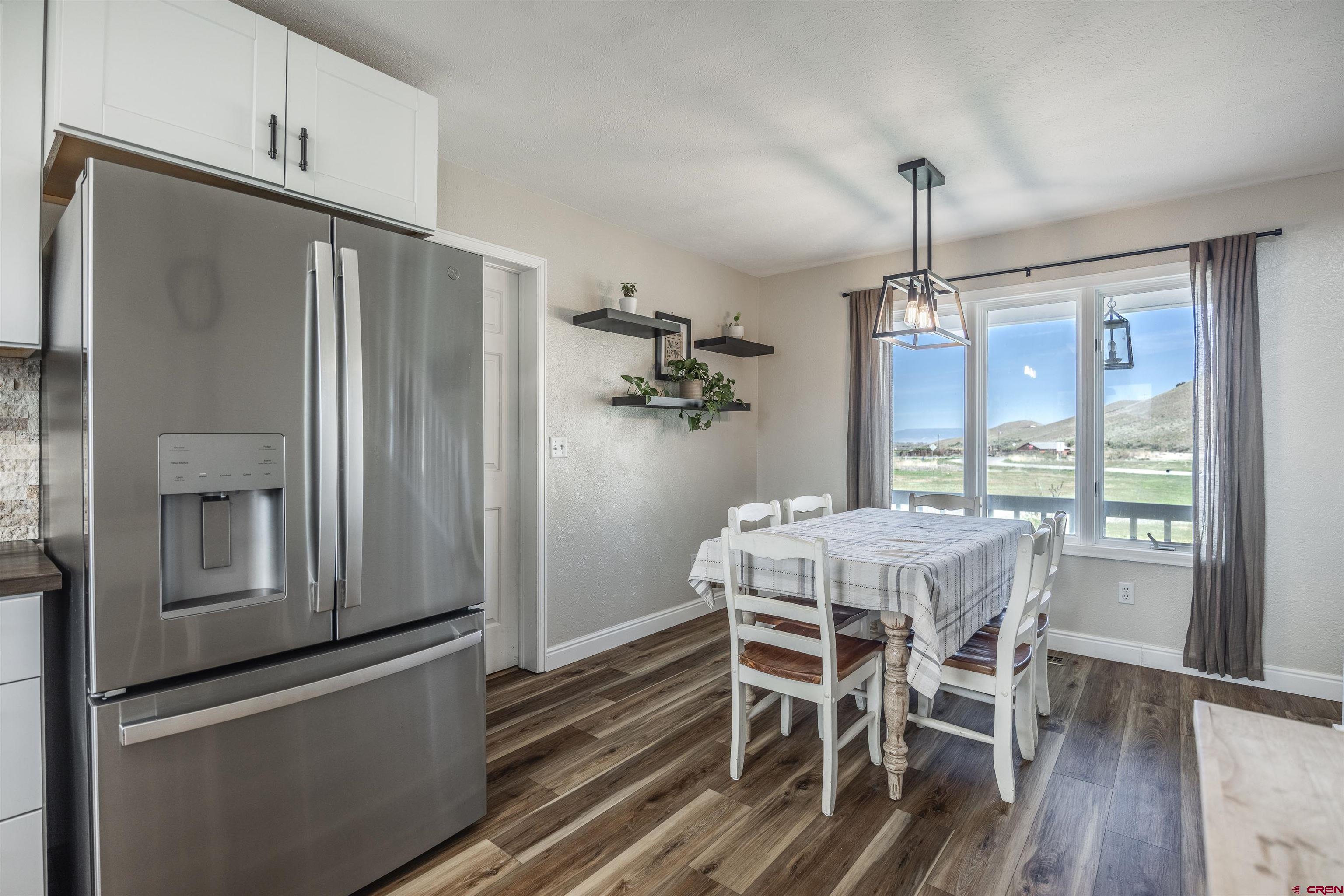 19555 6575th Road Montrose, CO 81403 - Photo 5 of 36 a view of a dining room with furniture window and wooden floor
