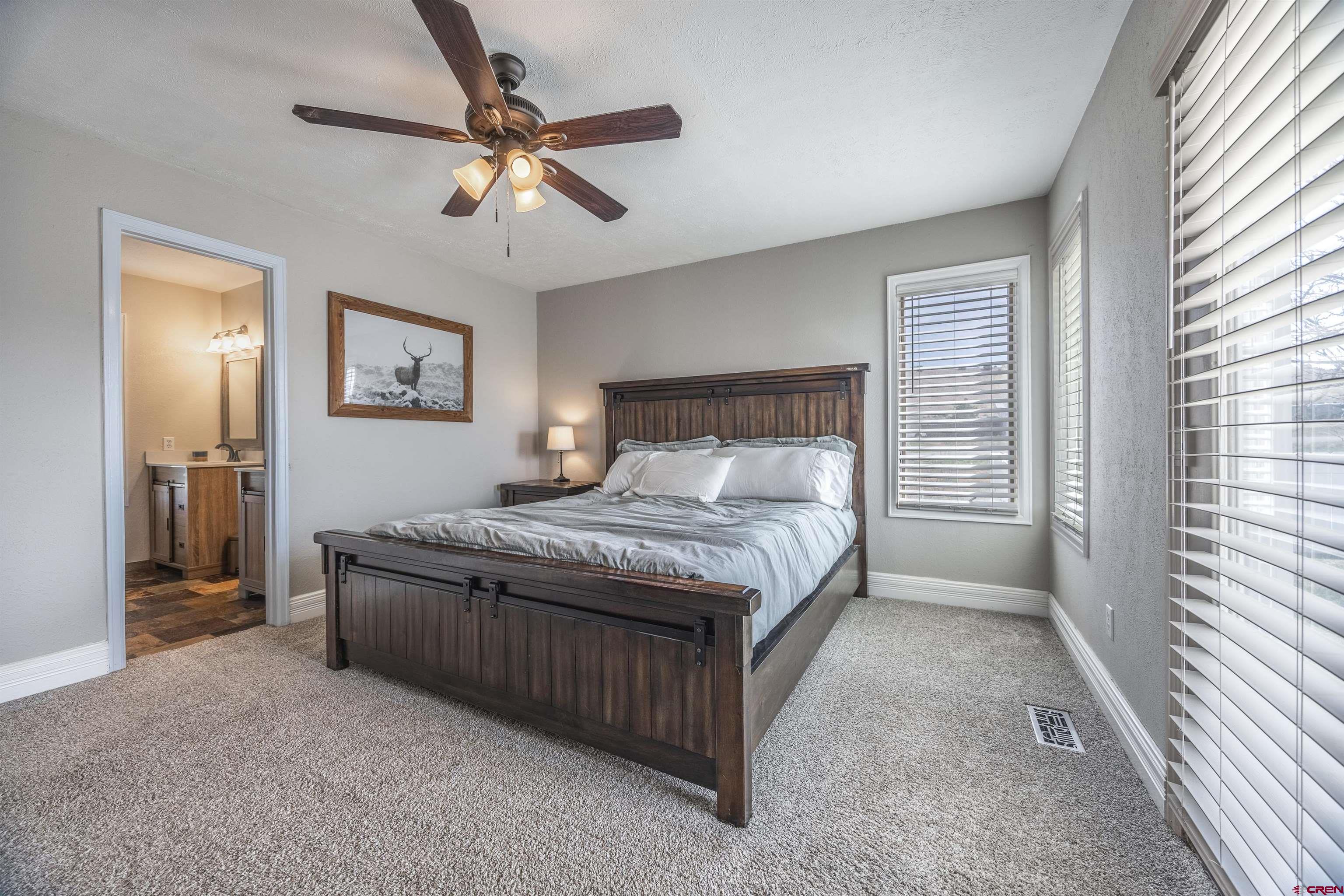 19555 6575th Road Montrose, CO 81403 - Photo 10 of 36 a bedroom with a bed and window