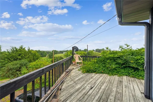 a view of a balcony with wooden floor