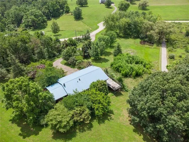 an aerial view of a house with a yard and lake view