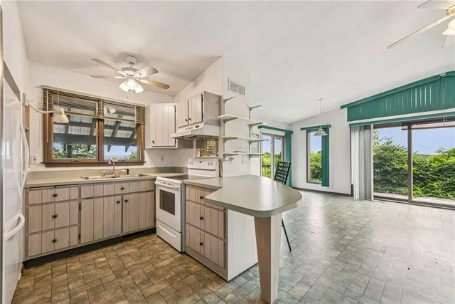 a open kitchen with stainless steel appliances granite countertop a sink and cabinets