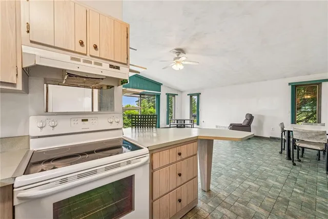 a kitchen with a stove and white cabinets