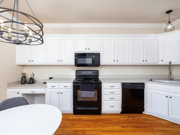 a kitchen with stainless steel appliances a stove top oven and cabinets