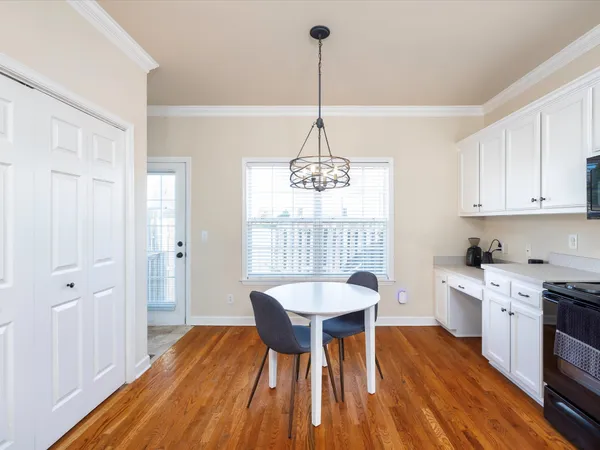 a view of a dining room with furniture window and wooden floor