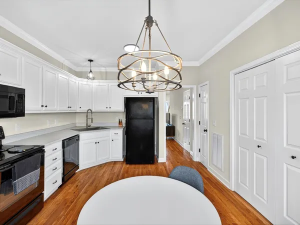 a kitchen with stainless steel appliances a refrigerator a sink dishwasher a stove with wooden floor