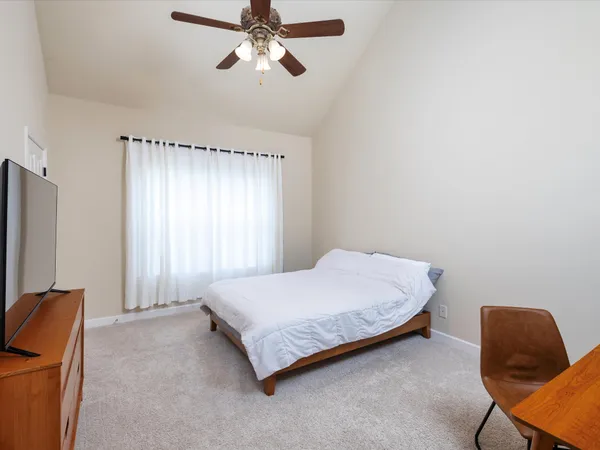 a bedroom with a bed and chair