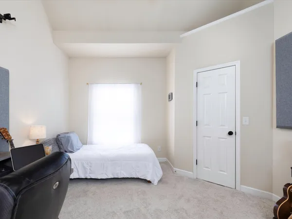 a bedroom with a bed and a lamp