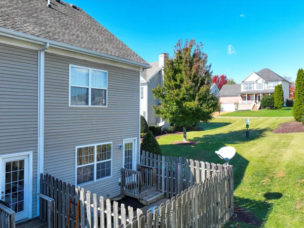 a view of a house with backyard and a tree