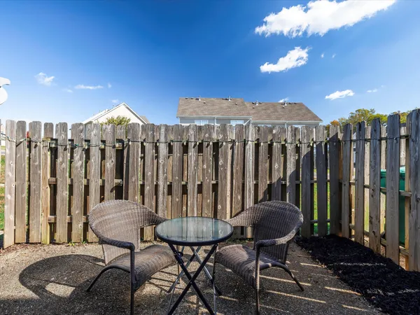 a view of a chairs and table in patio