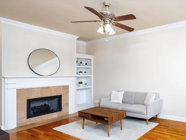 a living room with furniture a fireplace and a large mirror
