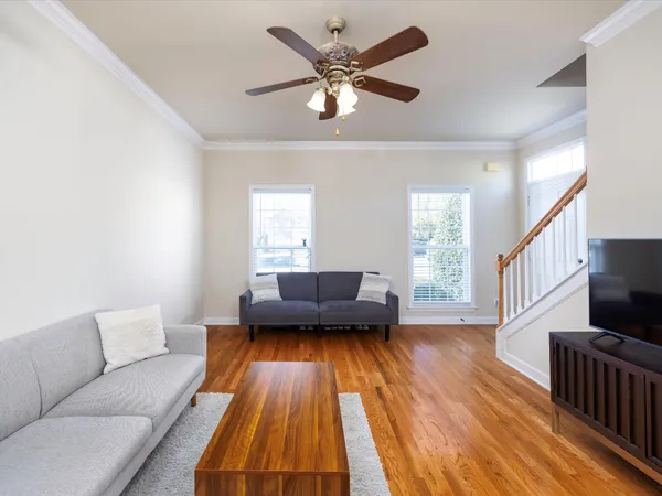 a living room with furniture and a wooden floor