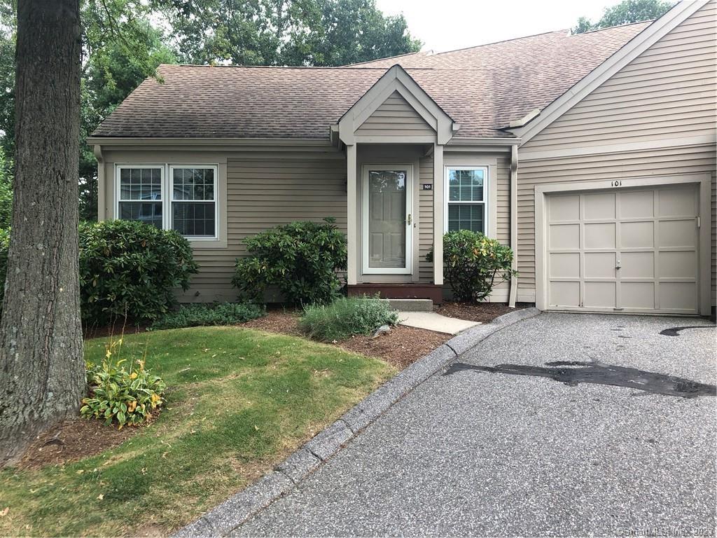 101 Mill Lane, Unit 101 Torrington, CT 06790 - Photo 1 of 1 a front view of a house with a yard and garage