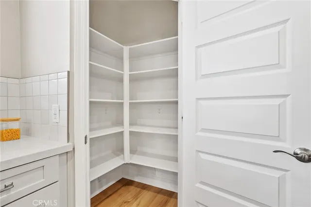 a view of walk in closet with empty racks