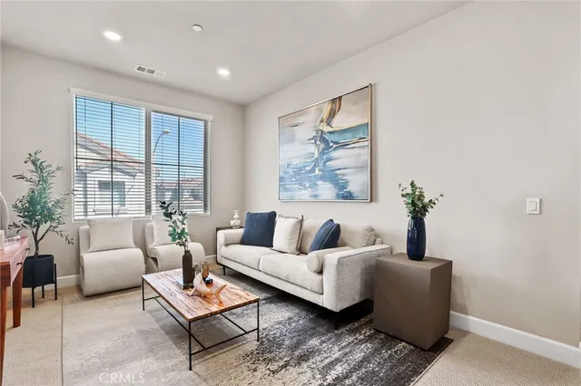 a living room with furniture and a potted plant