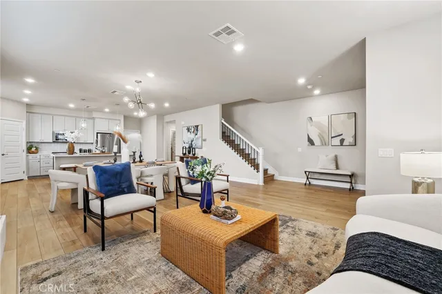 a living room with furniture and kitchen view