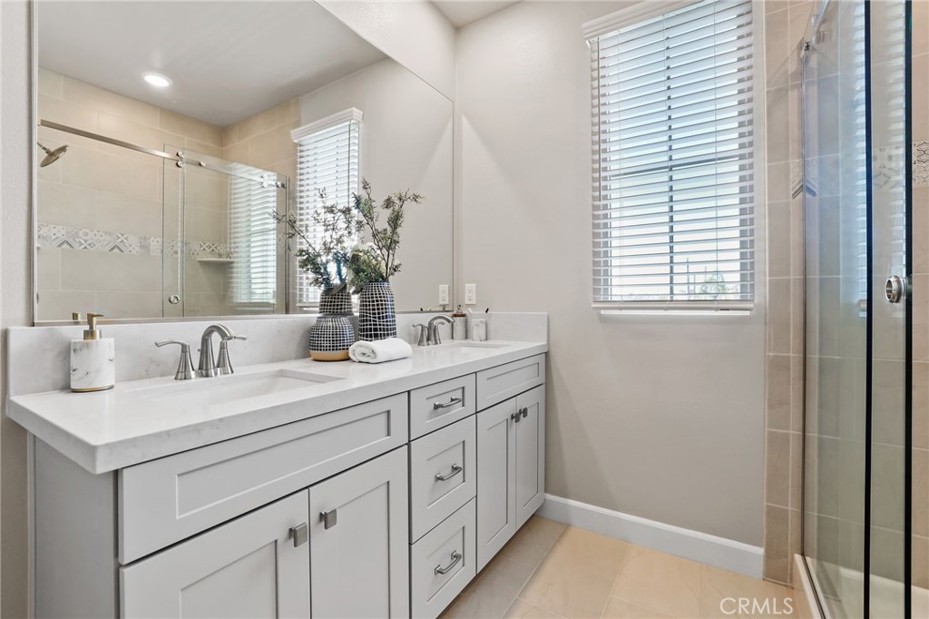 19091 Azul Lane Huntington Beach, CA 92648 - Photo 24 of 34 a bathroom with a double vanity sink and a mirror