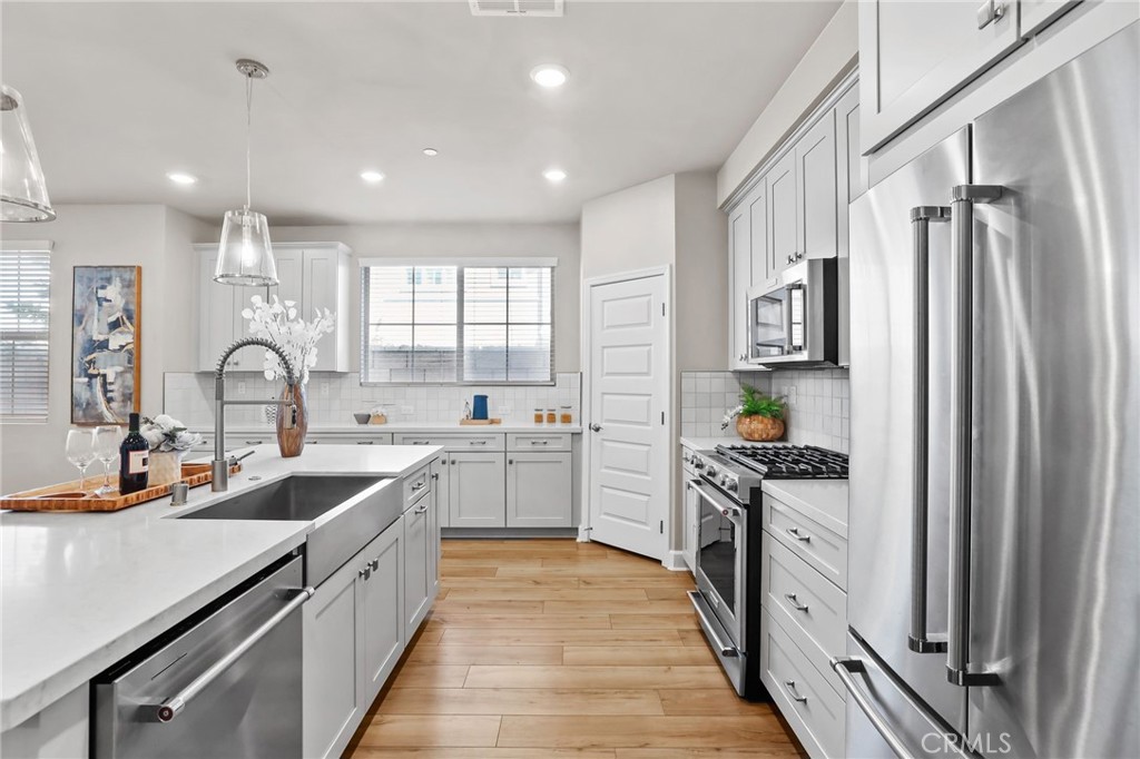 19091 Azul Lane Huntington Beach, CA 92648 - Photo 3 of 34 a kitchen with white cabinets and appliances