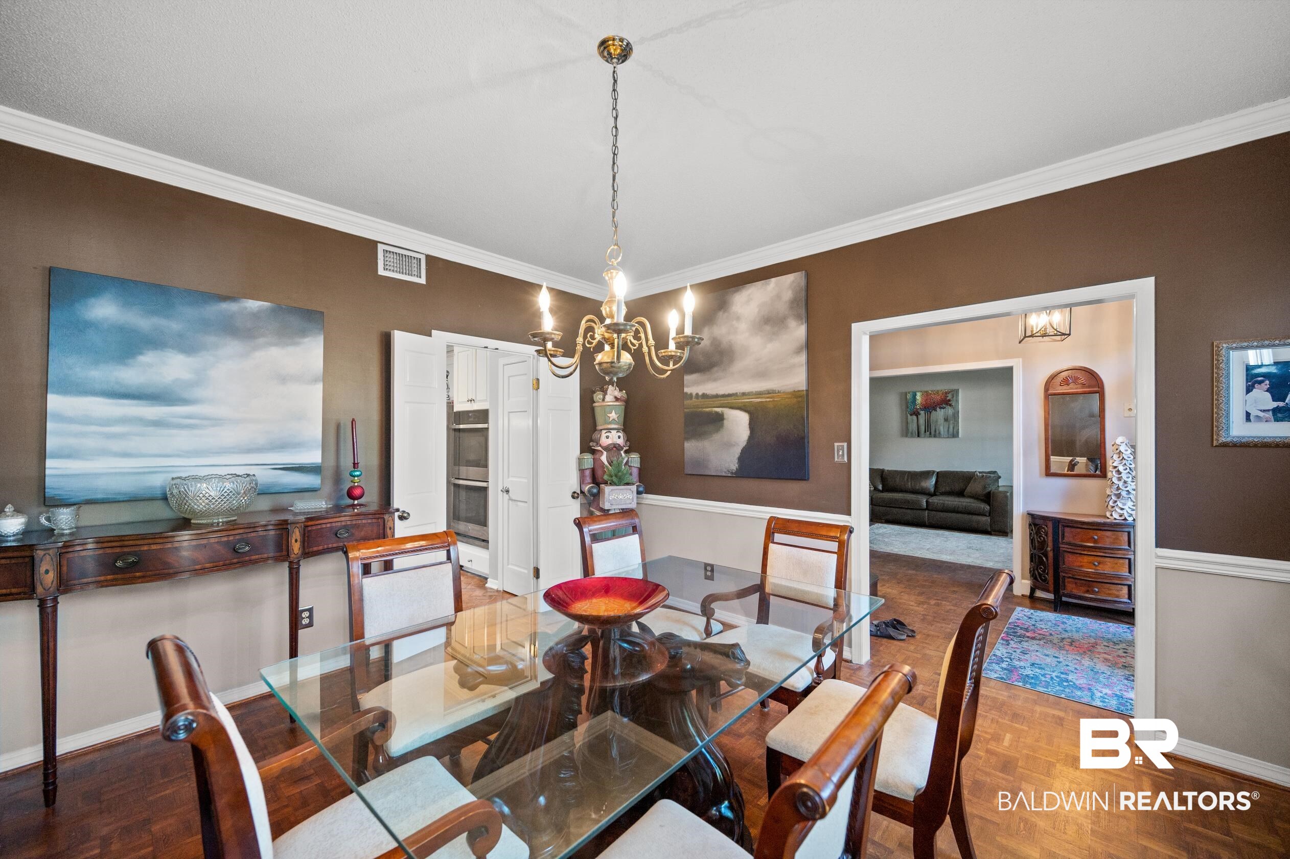 6705 Ridgeland Road South Mobile, AL 36695 - Photo 9 of 44 Dining room featuring parquet flooring, crown molding, and a chandelier