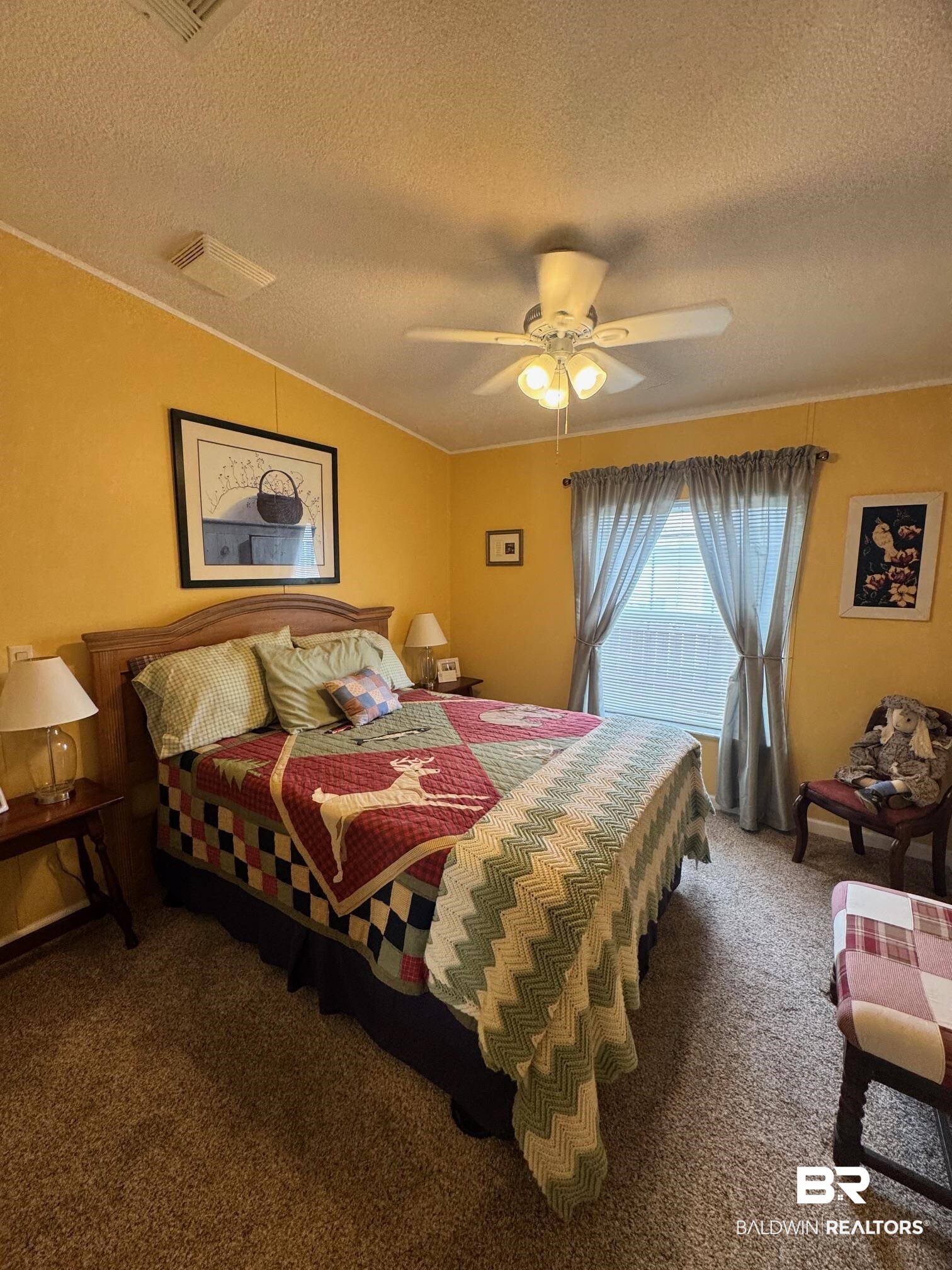 1165 Santa Anna Lane Lillian, AL 36549 - Photo 17 of 43 Bedroom with lofted ceiling, a textured ceiling, carpet floors, visible vents, and a ceiling fan