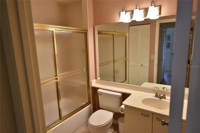 a bathroom with a toilet a sink and a shower