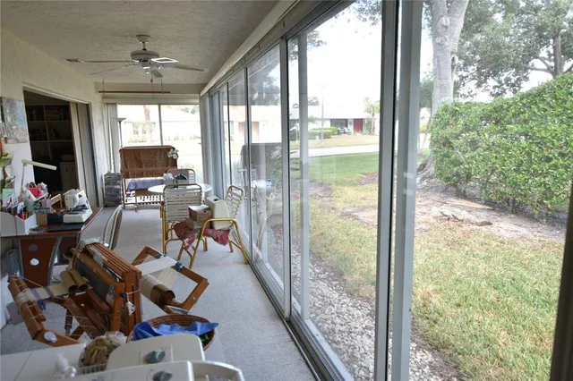 a view of a room with wooden floor and furniture