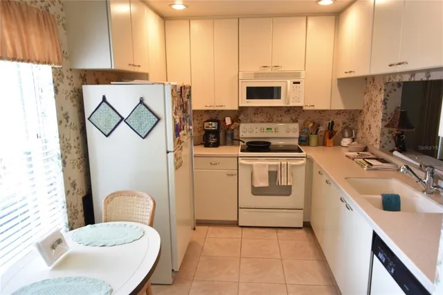a kitchen with a sink a stove and cabinets