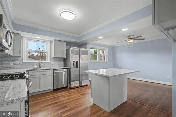 a kitchen with stainless steel appliances granite countertop a stove a sink dishwasher and a refrigerator