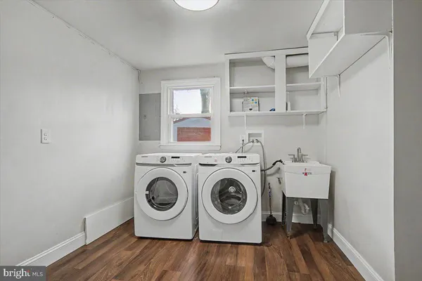 a utility room with dryer washer and sink