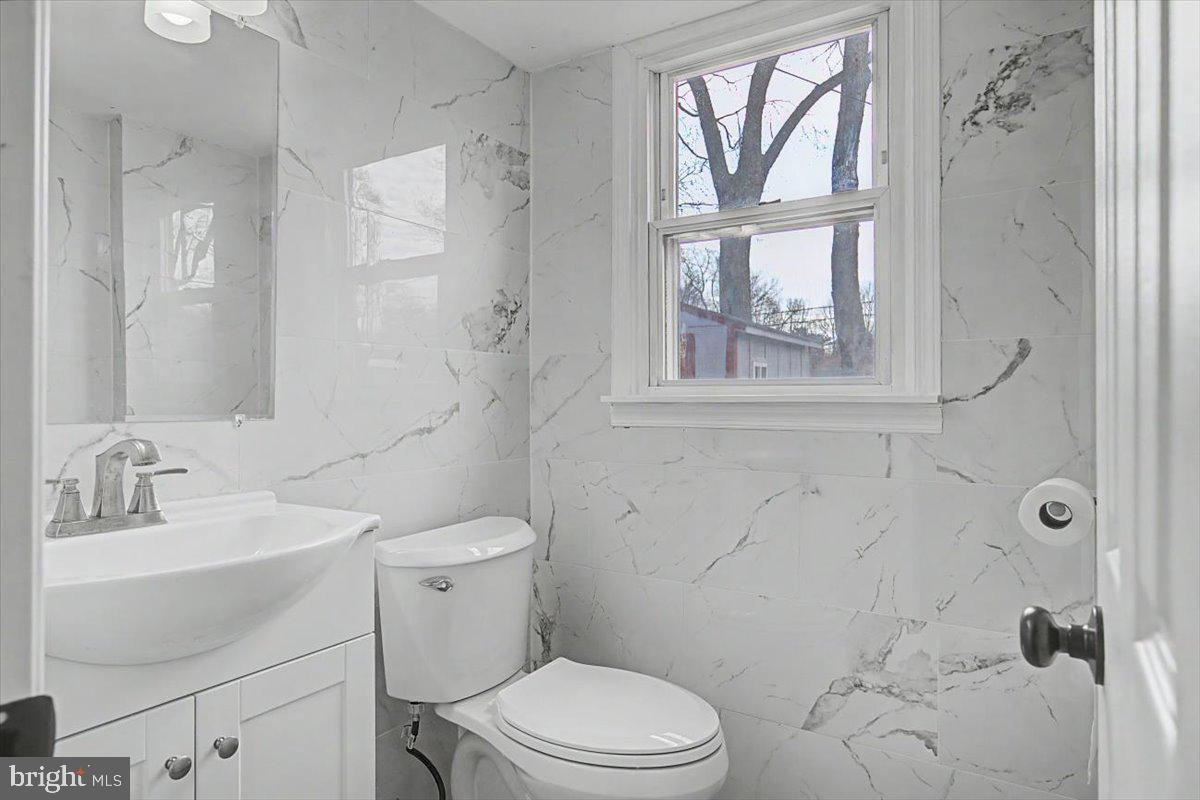 2209 Riviera Lane Wilmington, DE 19810 - Photo 11 of 43 a bathroom with a toilet sink vanity and windows