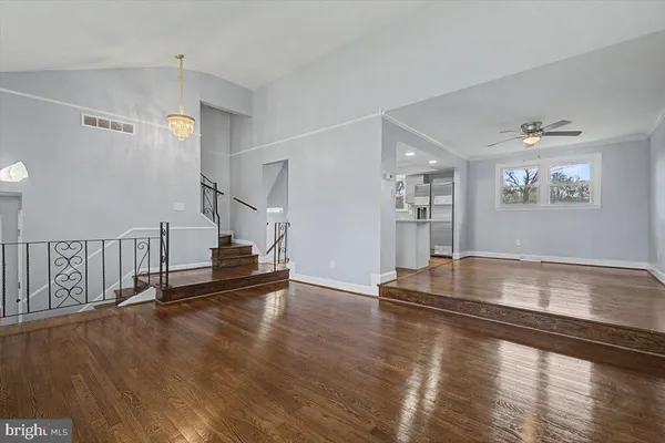 a view of a room with wooden floor and staircase