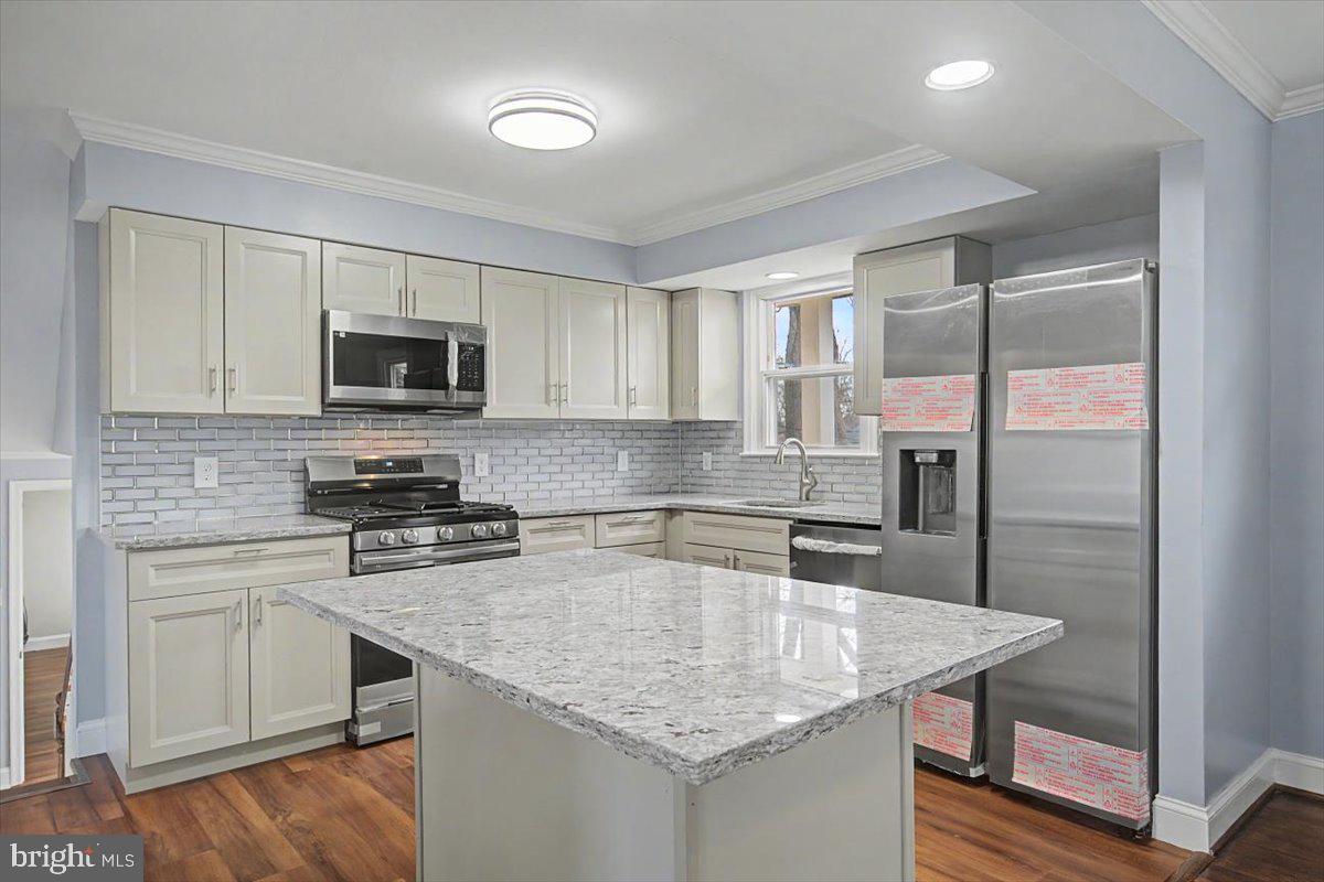 2209 Riviera Lane Wilmington, DE 19810 - Photo 19 of 43 a kitchen with stainless steel appliances granite countertop a sink a stove and microwave