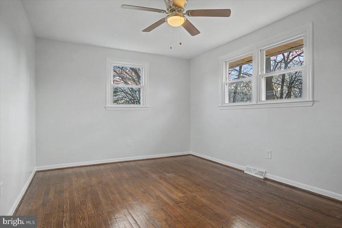 2209 Riviera Lane Wilmington, DE 19810 - Photo 24 of 43 a view of an empty room with wooden floor and a ceiling fan