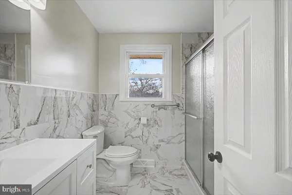 a bathroom with a toilet a sink and a shower