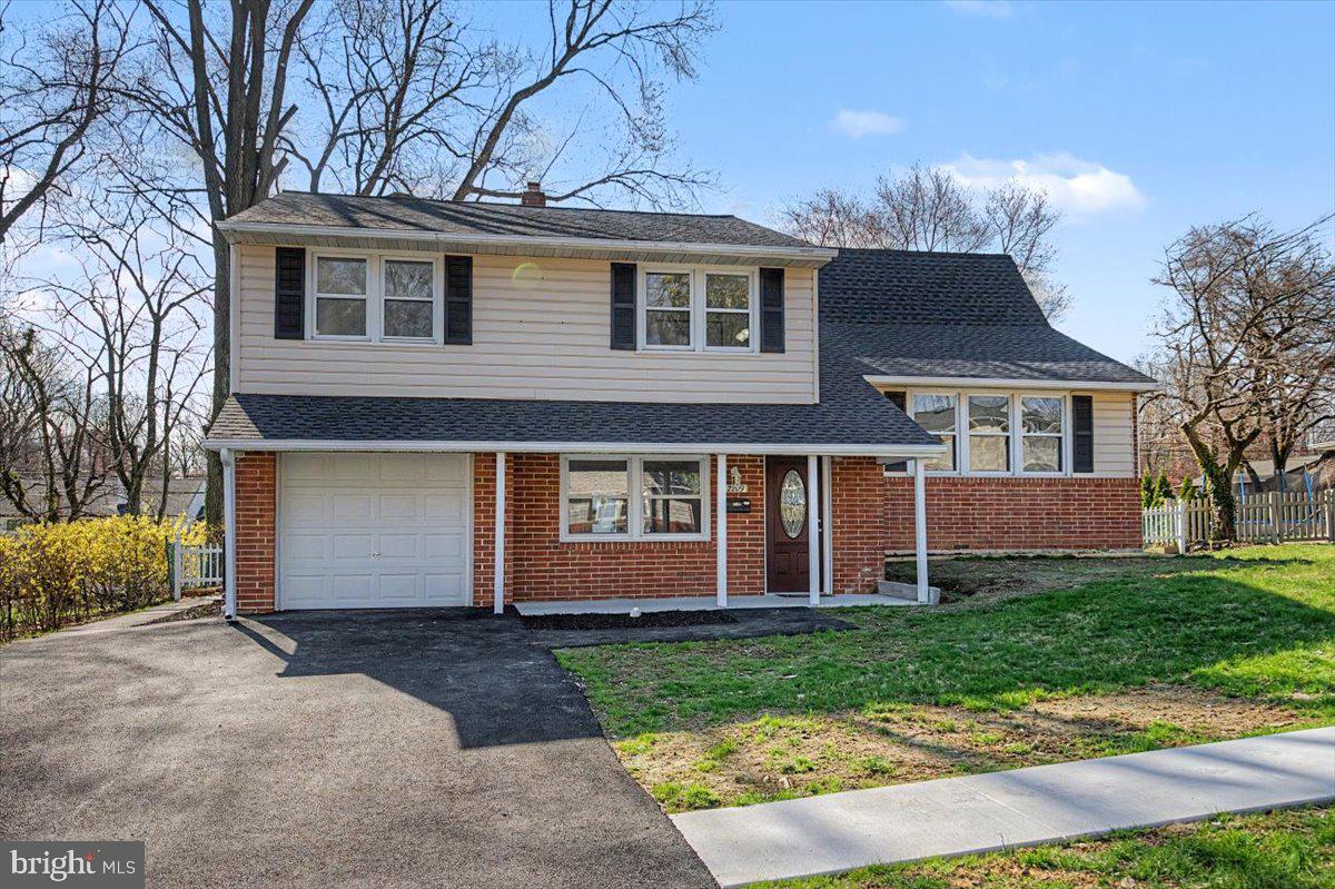2209 Riviera Lane Wilmington, DE 19810 - Photo 5 of 43 a front view of a house with a yard and garage