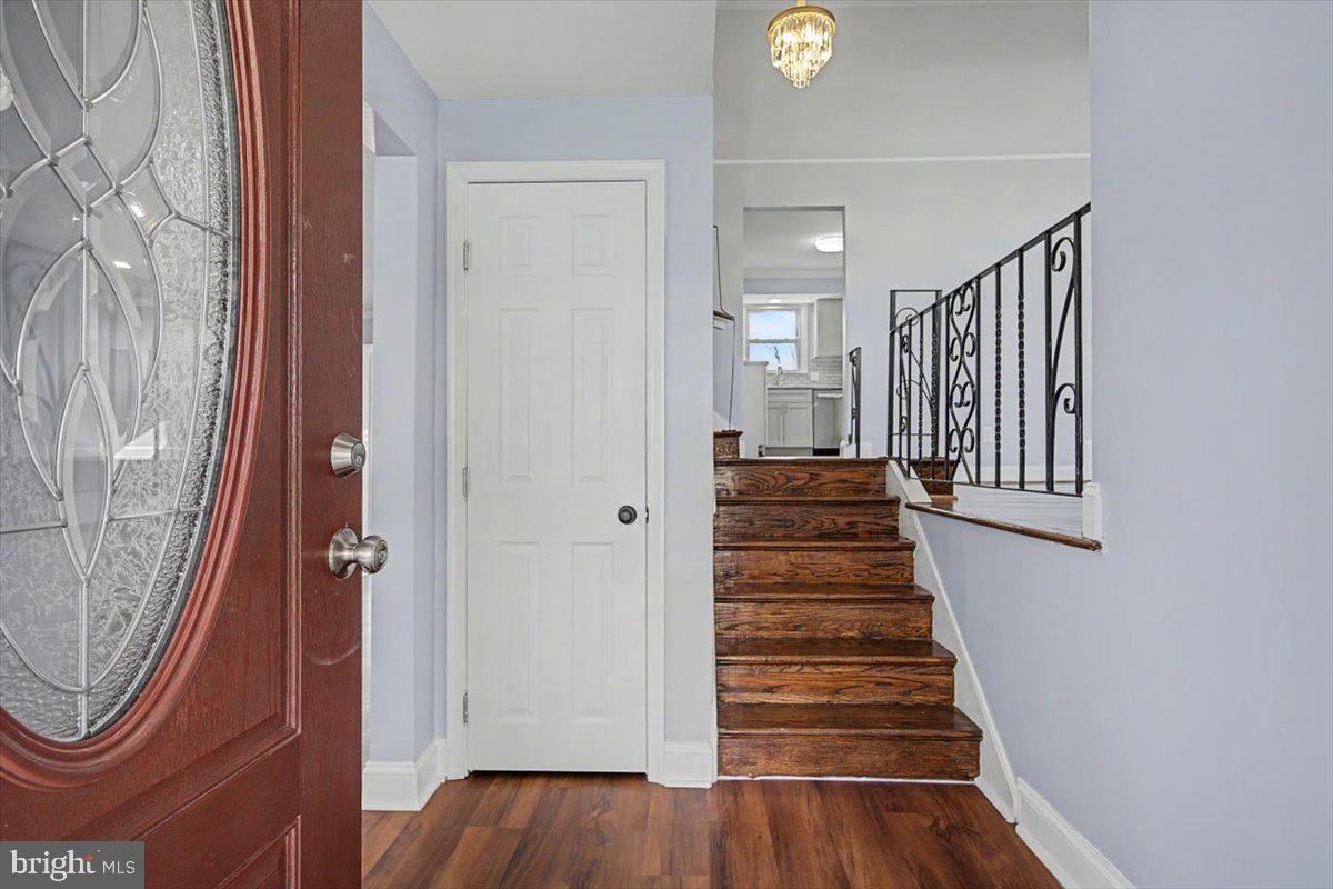 2209 Riviera Lane Wilmington, DE 19810 - Photo 6 of 43 a view of a hallway with wooden floor and staircase