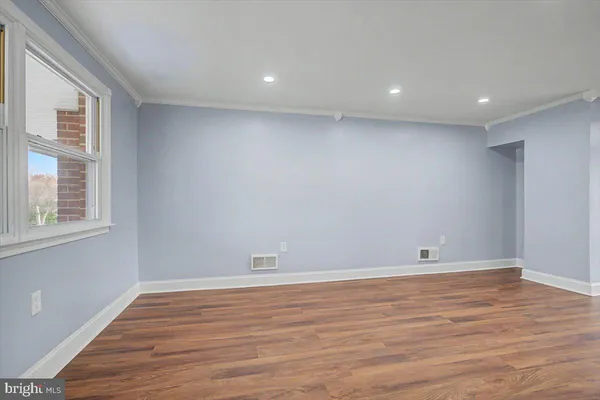 a view of room with wooden floor and natural light