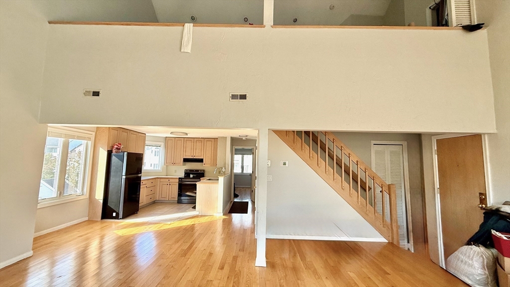 114 Burkhall Street, Unit R Weymouth, MA 02190 - Photo 4 of 15 a view of a living room with furniture and wooden floor