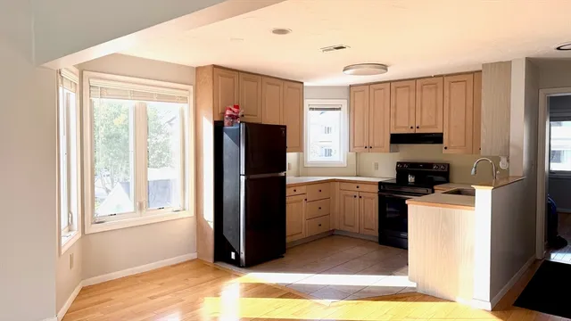 a kitchen with stainless steel appliances granite countertop a refrigerator stove and a sink