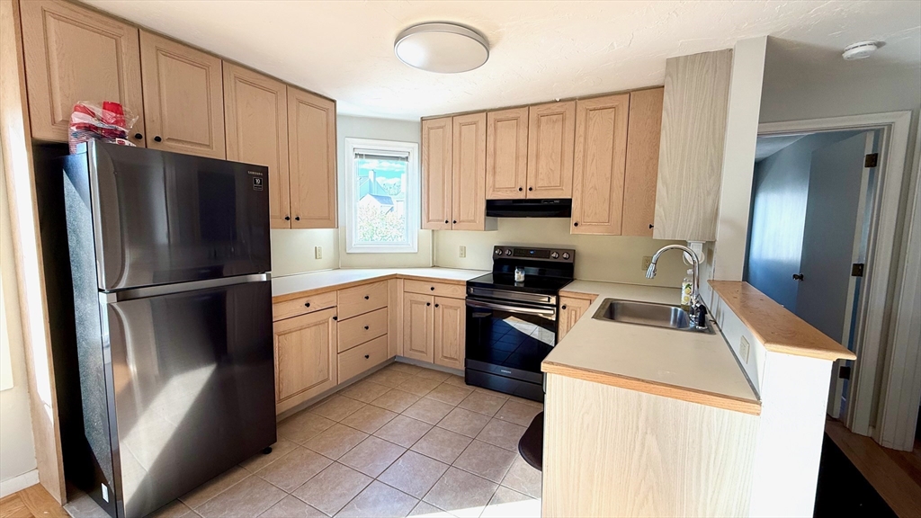 114 Burkhall Street, Unit R Weymouth, MA 02190 - Photo 7 of 15 a kitchen with a refrigerator sink and stove