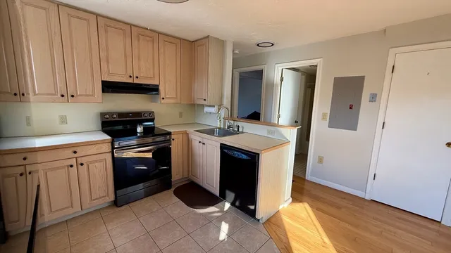 a kitchen with a sink appliances and cabinets