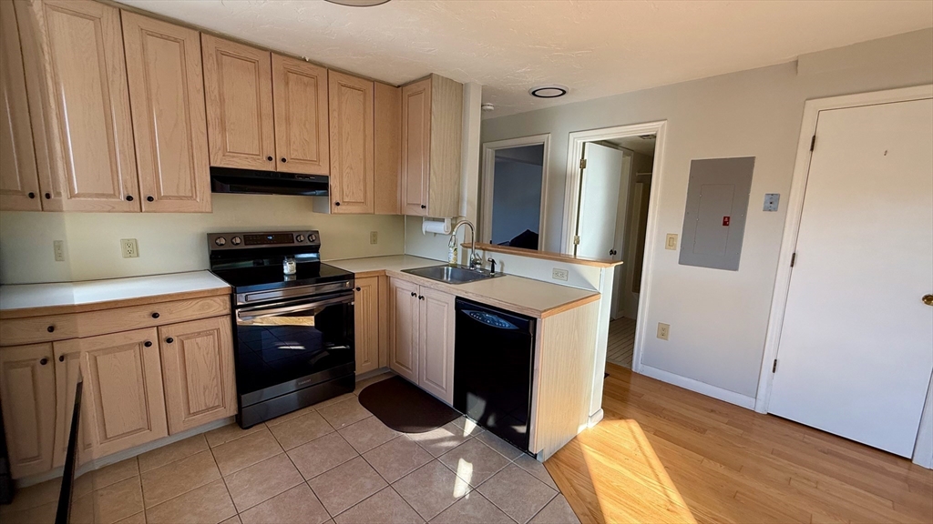 114 Burkhall Street, Unit R Weymouth, MA 02190 - Photo 8 of 15 a kitchen with a sink appliances and cabinets