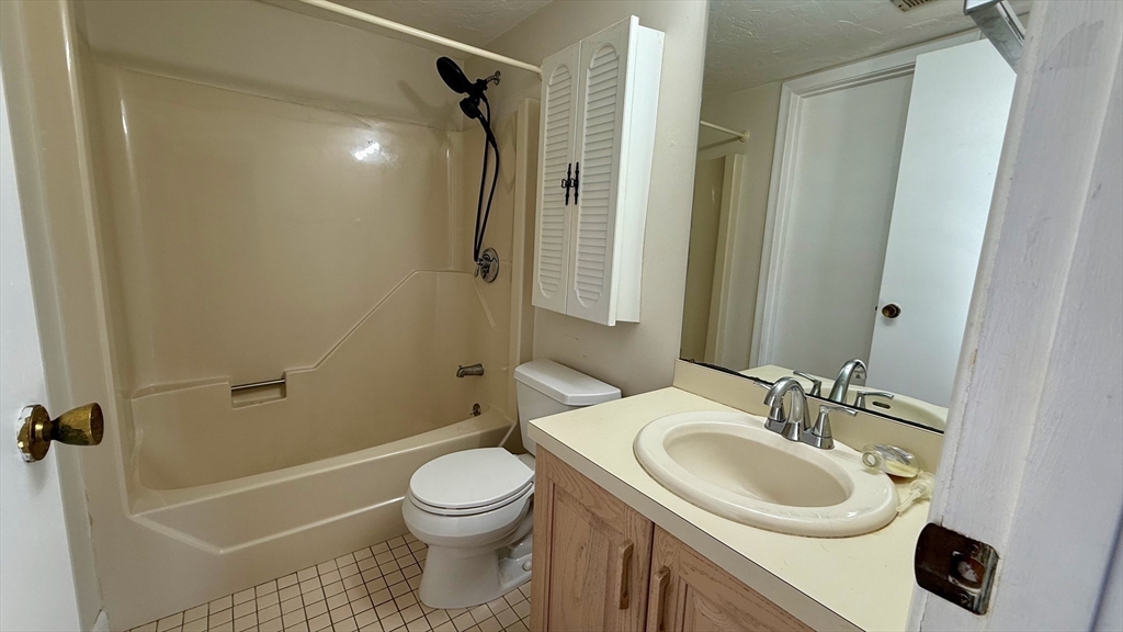 114 Burkhall Street, Unit R Weymouth, MA 02190 - Photo 9 of 15 a bathroom with a sink toilet and shower