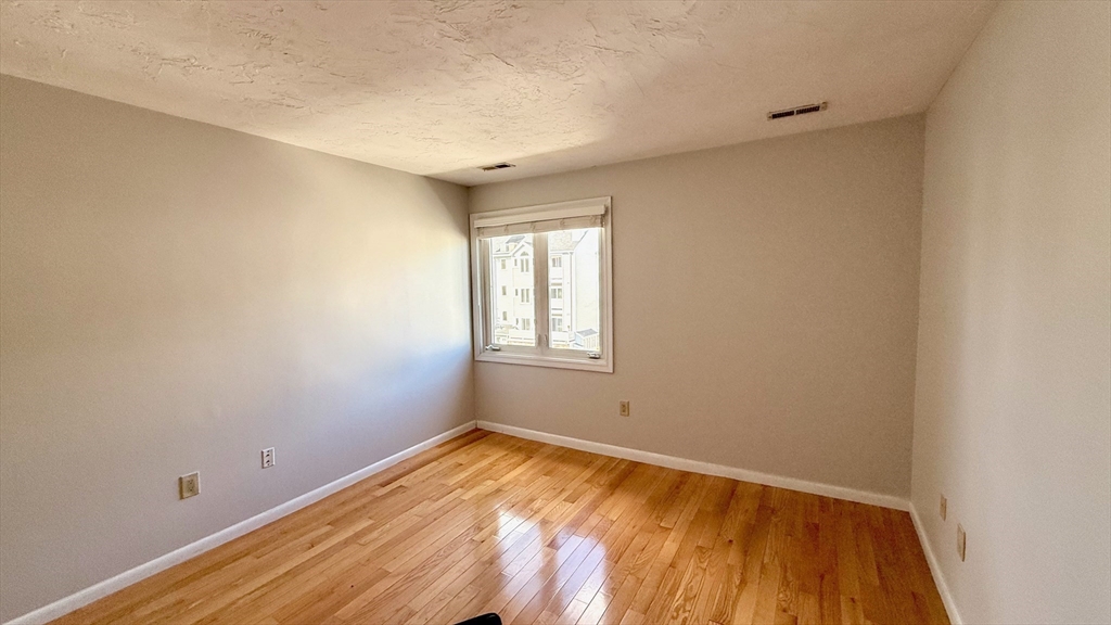 114 Burkhall Street, Unit R Weymouth, MA 02190 - Photo 10 of 15 a view of empty room with wooden floor
