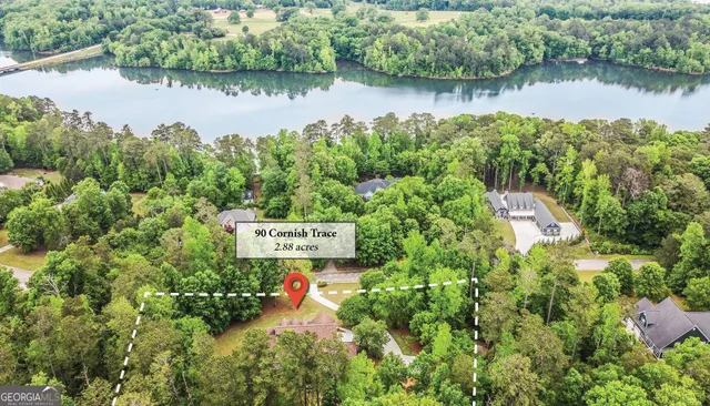 an aerial view of a house with pool and lake view