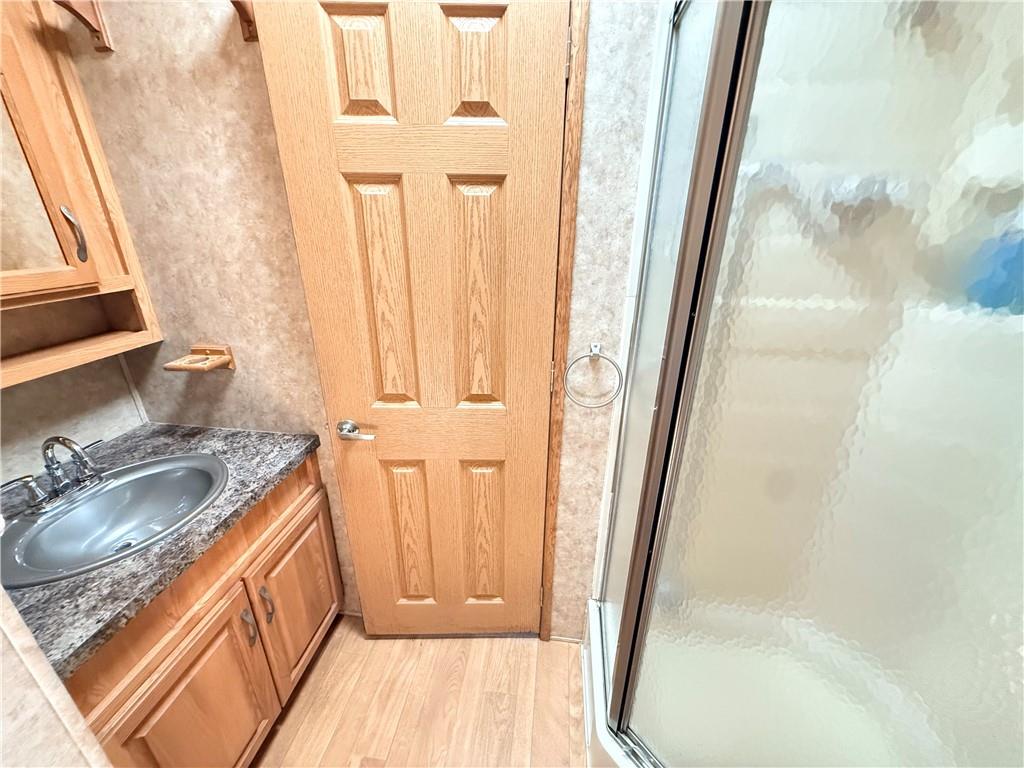 321 Dark Hollow Road Confluence, PA 15424 - Photo 12 of 18 a bathroom with a sink a mirror and a shower