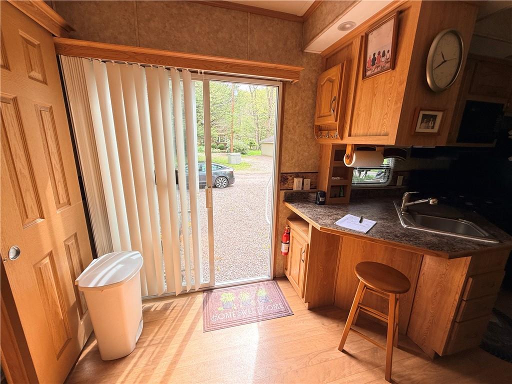 321 Dark Hollow Road Confluence, PA 15424 - Photo 7 of 18 a kitchen with stainless steel appliances granite countertop a refrigerator a stove a sink and white cabinets with wooden floor