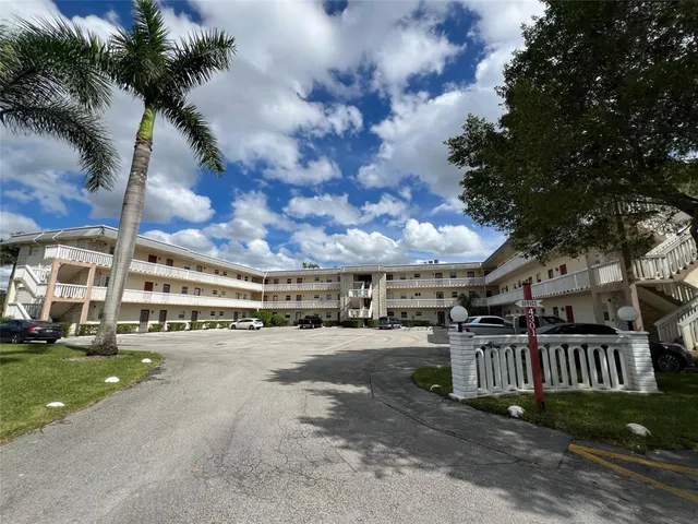 a view of a street with cars parked