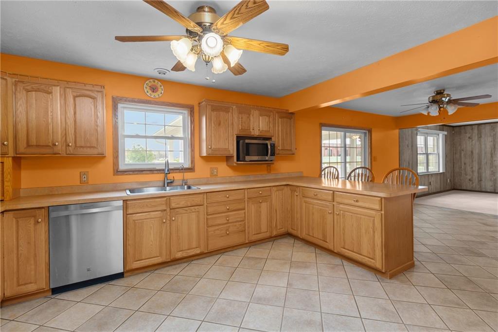 223 Balsinger Road Uniontown, PA 15401 - Photo 14 of 50 a kitchen with stainless steel appliances granite countertop a sink and cabinets