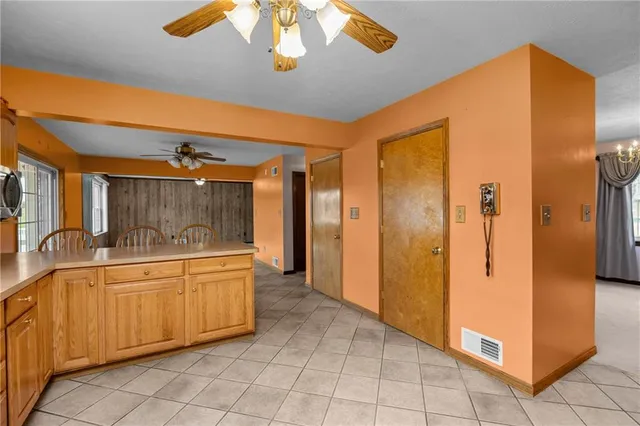 a view of a livingroom with furniture and a ceiling fan