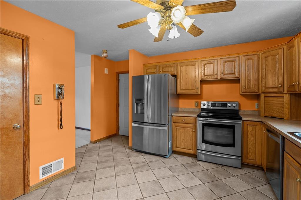 223 Balsinger Road Uniontown, PA 15401 - Photo 17 of 50 a kitchen with stainless steel appliances granite countertop a refrigerator a stove and a sink